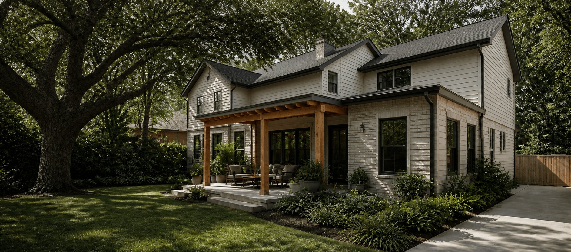 Brick and siding home in north Houston with a cedar-post porch and a new cedar fence under mature oak trees